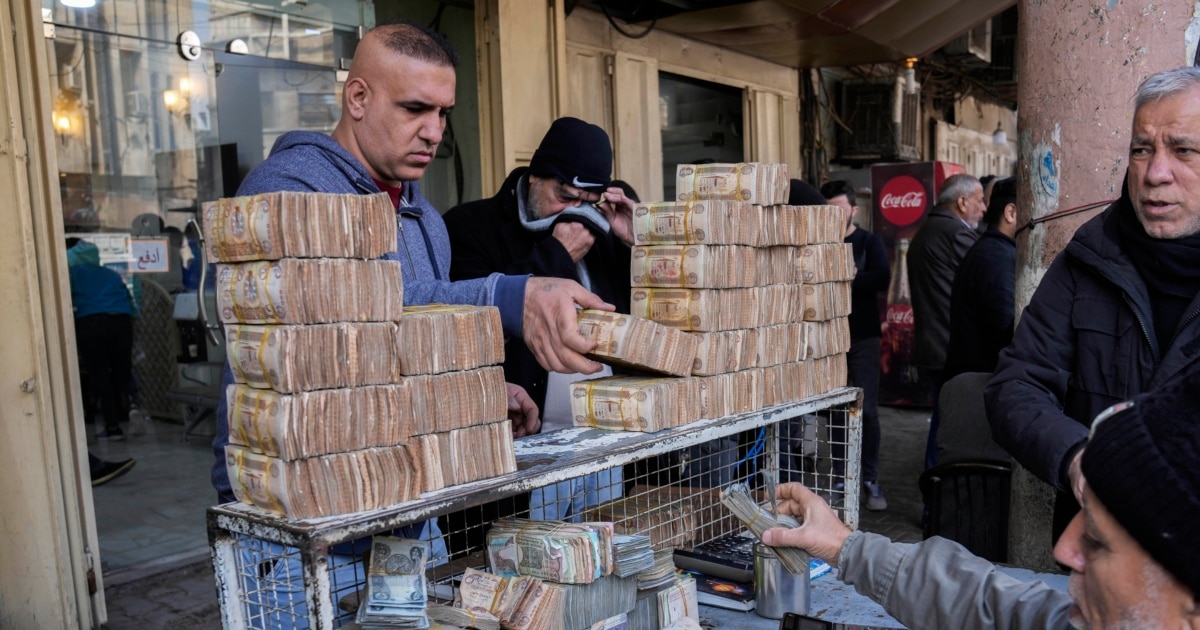 Iraq devalues dinar to ease economic pressure