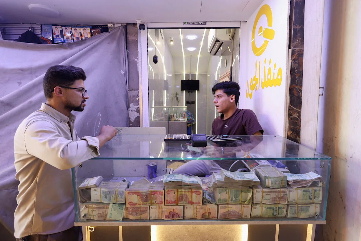 Why has Iraq devalued its currency, and why are some MPs against it?
